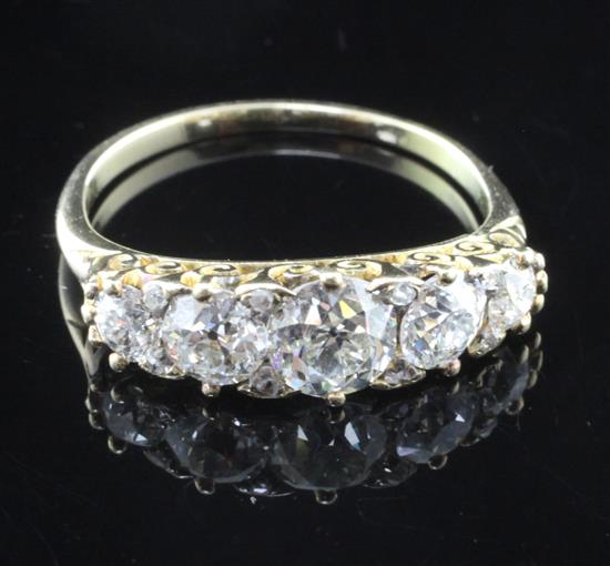 A gold and graduated five stone diamond half hoop ring, size L.